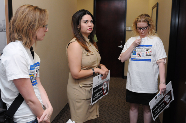 Immigration Reform for Nevada supporters Katelyn Franklin, from left, Vanessa Becerra-Bautista and Emily Ross, wait outside of the office of U.S. Rep. Joe Heck, R-Nev., in protest of the Congress ...