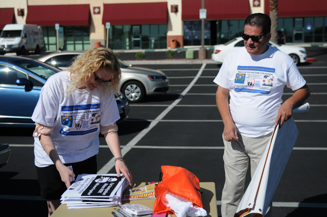 Emily Ross, left, spokeswoman with Immigration Reform for Nevada, and Director Carlos H. Silva Sr., prepare for a fasting event outside of the office of U.S. Rep. Joe Heck, R-Nev., in protest of t ...