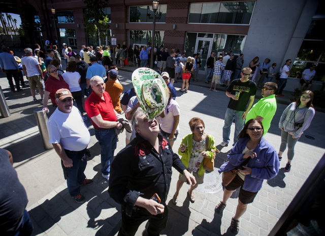 Daniel Eric Mann "Juggling Taxi Driver) balances his hat while people stand in line to ride the High Roller at The Linq on Monday, March 31, 2014. The world's tallest observation wheel opened ...