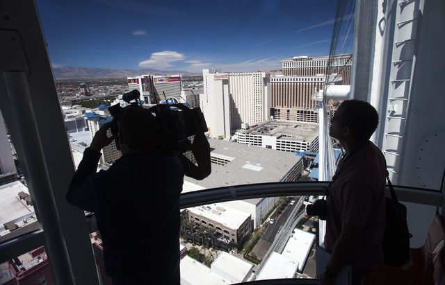 Dave Meador,left, with Clark County TV and Todd Witch with Civil Engineering ride the High Roller at The Linq on Monday, March 31, 2014. The world's tallest observation wheel opened to the public  ...