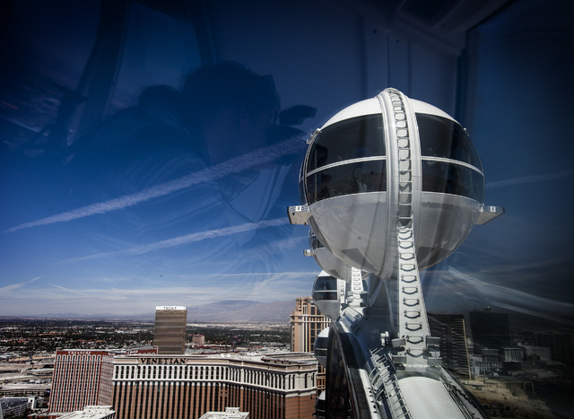 A reflection of a man taking a photo as seen  Monday, March 31, 2014 while riding the High Roller at The Linq. The world's tallest observation wheel opened to the public today.(Jeff Scheid/Las Veg ...