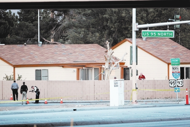Las Vegas police investigate the scene of an officer-involved shooting at the onramp to north onramp to U.S. Highway 95 at Charleston Boulevard Monday, March 3, 2014. Officers were investigating a ...
