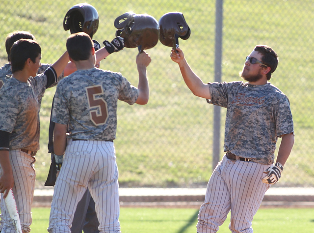 Bonanza's Keith Werner, right, celebrates with teammates, after hitting a home run against Green Valley on Friday. The Bengals won, 9-5. (Chase Stevens/Las Vegas Review-Journal)