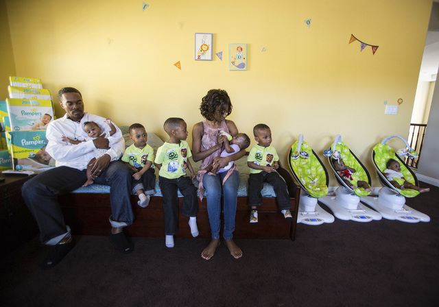 Deon Derrico,left, and his wife Evonne with their seven of their nine children at their home in North Las Vegas on Monday, March 24, 2014. Evonne Derrico gave birth to quintuplets on Sept. 6.(Jeff ...