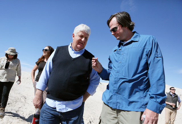 Rep. Rob Bishop, R-Utah, center, looks at a fossil with Ryann Juden (cq), right, executive government affairs liaison for the City of North Las Vegas, during a tour of a portion of the proposed Tu ...