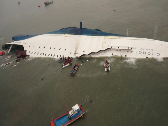 South Korean rescue team boats and fishing boats try to rescue passengers of a ferry sinking off South Korea's southern coast, in the water off the southern coast near Jindo, south of Seoul, Wedne ...