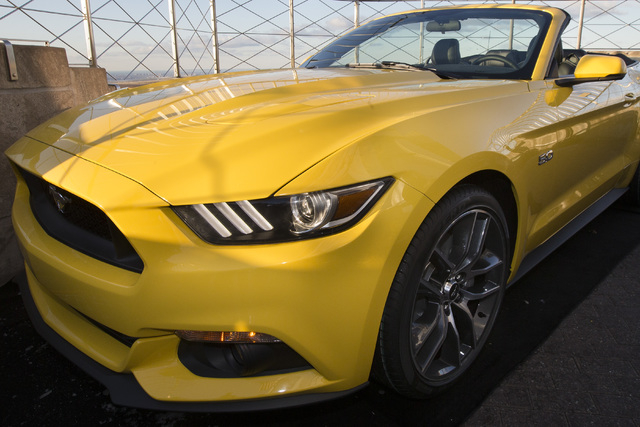 Ford Motor Company introduces the all-new 2015 Mustang convertible on the 86th floor observation deck of the Empire State Building during the New York International Auto Show, Wednesday, April 16, ...