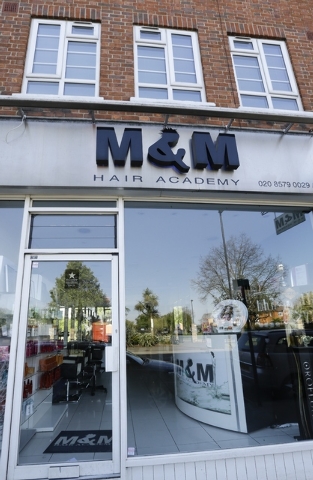 A view of M&M Hair Academy in London, Wednesday, April 16, 2014. Staff at a London hair salon say they had a close shave with North Korean officials after using the country's leader, Kim Jong Un,  ...