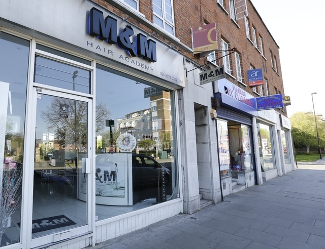 A view of M&M Hair Academy in London, Wednesday, April 16, 2014. Staff at a London hair salon say they had a close shave with North Korean officials after using the country's leader, Kim Jong Un,  ...