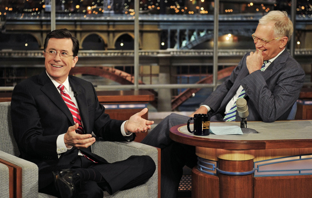 On May 3, 2012 Stephen Colbert, left, host of the "Colbert Report" on the Comedy Central Network, has a laugh on stage with host David Letterman on the set of the "Late Show" with David Letterman, ...