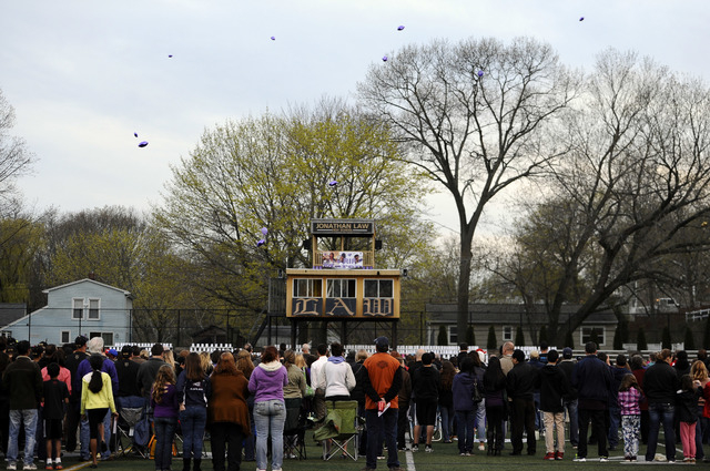 People release balloons as they attend during a vigil for Maren Sanchez on the football field at Jonathan Law High School, Monday, April 28, 2014, in Milford, Conn. Sanchez was fatally stabbed ins ...