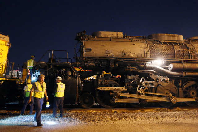 A crew inspects Big Boy No. 4014 moments after the historic steam locomotive arrives at Union Pacific Tuesday, April 29, 2014, in Las Vegas.  (Ronda Churchill/Las Vegas Review-Journal)