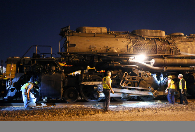 A crew inspects Big Boy No. 4014 moments after the historic steam locomotive arrives at Union Pacific Tuesday, April 29, 2014, in Las Vegas.  (Ronda Churchill/Las Vegas Review-Journal)