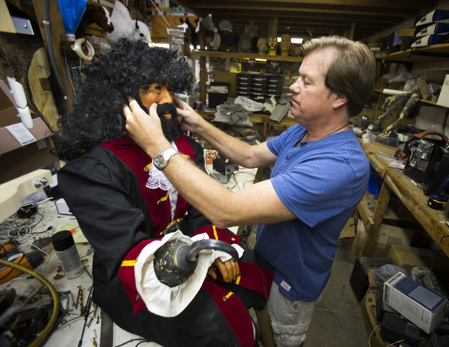 Olaf Stanton, owner of Characters Unlimited in Boulder City, works on a refurbished pirate in his workshop April 1. He built the character back in 1992. The company makes hundreds of life-sized ch ...