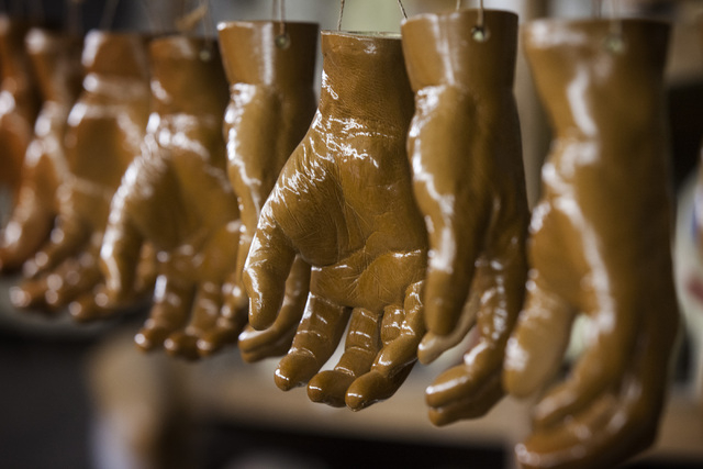 Hands hang to dry from a fresh coat of paint April 1. (Jeff Scheid/Las Vegas Review-Journal)