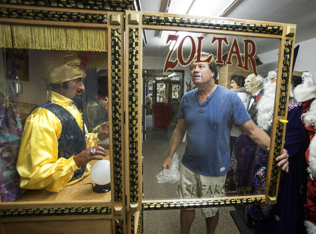 Olaf Stanton, owner of Characters Unlimited in Boulder City, inspects a Zoltar fortune-telling machine. (Jeff Scheid/Las Vegas Review-Journal)