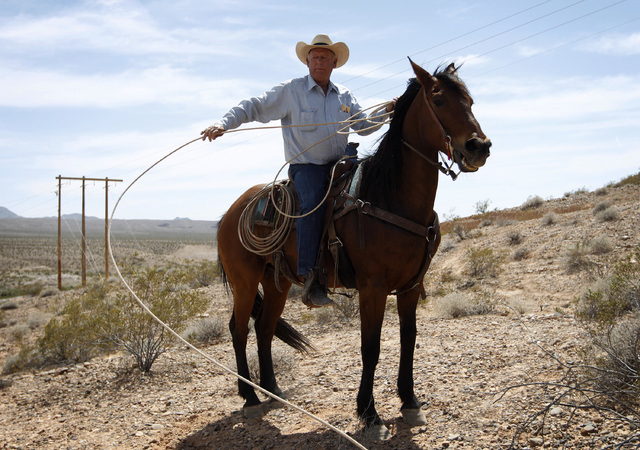 Rancher Cliven Bundy pulls in a rope while on horseback at a protest area near Bunkerville, Nev. Wednesday, April 16, 2014.  (John Locher/Las Vegas Review-Journal)