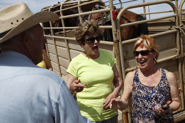 Sunny Almeida, right, and Virginia Souza react to meeting Cliven Bundy at a protest area near Bunkerville, Nev. Wednesday, April 16, 2014. (John Locher/Las Vegas Review-Journal)