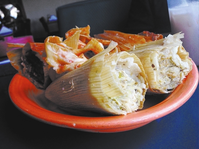 The larger than normal green tamales, front, are made with shredded chicken in a hot sauce, and the red tamales, back, are made from pulled pork in a mild sauce. (Sandy Lopez/View)