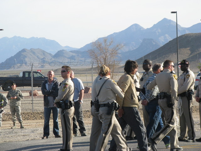 From left, Robert Majors and Dan Shay are taken into custody by police during a peaceful protest of military drones outside Las Vegas. (Courtesy Nevada Desert Experience)