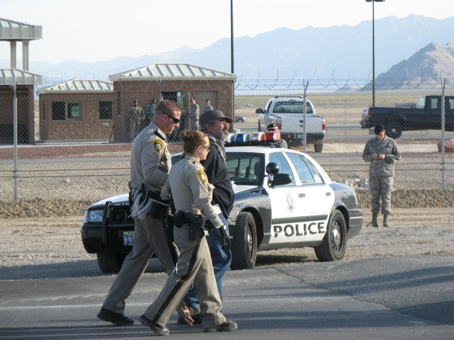 Peace protester Brian Terrell walks away from Creech Air Force Base in police custody. (Courtesy Nevada Desert Experience)