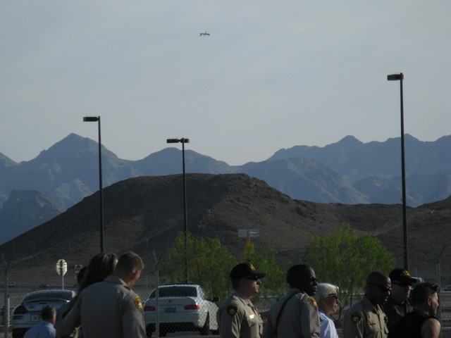 From left, Seamus Knight, Margaret McChesney and Marcus Page walk peacefully away from a drone protest at Creech Air Force Base, outside Las Vegas. (Courtesy Nevada Desert Experience)