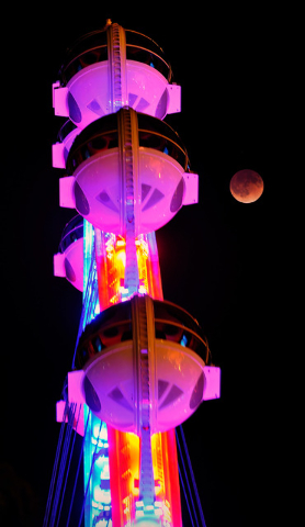 A total lunar eclipse appears next the Las Vegas High Roller at The LINQ early Tuesday, April 15, 2014. People in most of north and south America were able to witness this year's first total lunar ...