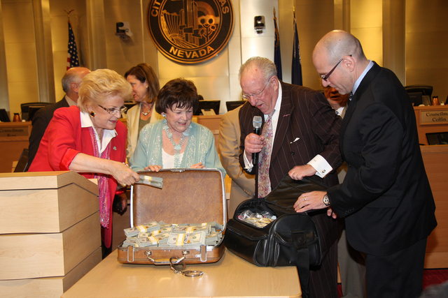 Las Vegas Mayor Carolyn Goodman, left, and Councilwoman Lois Tarkanian look over the $1.5 million in cash delivered Wednesday by former Mayor Oscar Goodman, second from right, and Mob Museum Execu ...