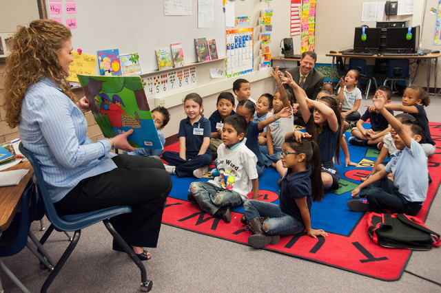 Kindergarten teacher Alex Skeary, left, reads a story to her class, as Clark County Superintendent Pat Skorkowsky, top right, participates at Gene Ward Elementary School in Las Vegas Thursday, Apr ...