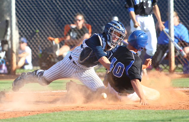 Basic's Isaac Perez (40) slides into home plate as Chatsworth catcher Jake Ryan loses control of the ball during the sixth inning in the championship game of the Blazer Spring Bash. Basic tied the ...