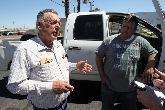 Embattled Bunkerville rancher Cliven Bundy, left, and his son Dave Bundy talk to a reporter on the corner of North Las Vegas Boulevard and East Stewart Avenue in downtown Las Vegas Monday, April 7 ...