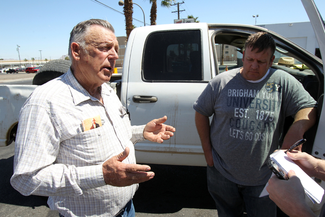 Embattled Bunkerville rancher Cliven Bundy, left, and his son Dave Bundy talk to a reporter on the corner of North Las Vegas Boulevard and East Stewart Avenue in downtown Las Vegas Monday, April 7 ...
