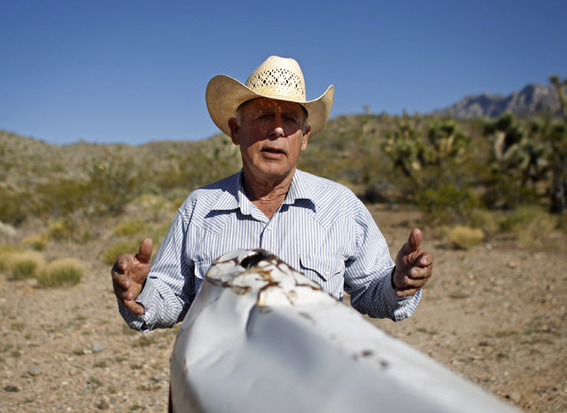 Cliven Bundy stands behind his truck on public land near Bunkerville, Nev. Tuesday, April 10, 2012. The Bureau of Land Management has told Bundy it will come and remove his cattle and improvements ...