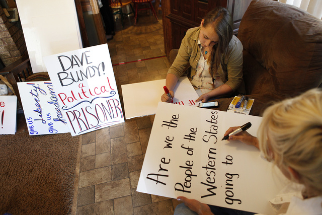 Chrisie Marshall, right, and Sierra Marshall make signs at the Bundy ranch near Bunkerville Nev. Monday, April 7, 2014, 2014. The Bureau of Land Management has begun to round up what they call &qu ...