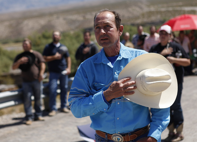 Chris Miller holds his hand over his heart during a rally in support of Cliven Bundy near Bunkerville Nev. Monday, April 7, 2014, 2014. The Bureau of Land Management has begun to round up what the ...