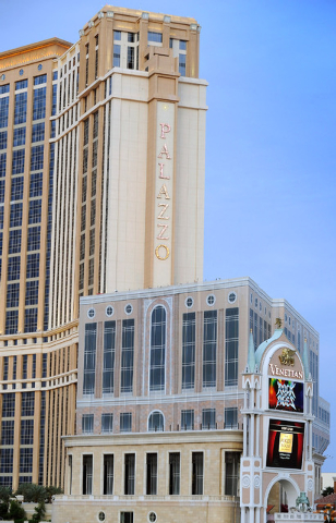 The unfinished tower is seen in the shadows of The Palazzo, known as the St. Regis Residences condominiums, is covered with giant sheets of cloth printed with the image of a completed building on  ...