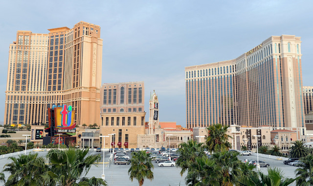 The unfinished tower is seen between The Palazzo and The Venetian, known as the St. Regis Residences condominiums, is covered with giant sheets of cloth printed with the image of a completed build ...