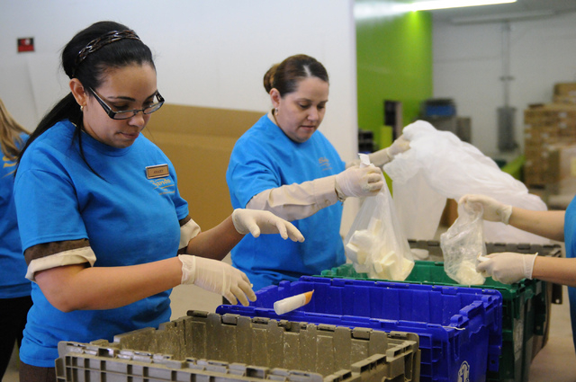 Las Vegas Sands Corp. team volunteers Anaisy Hernandez, left, and Ana Yanez, assort through soap bottles that will be distributed to local and international organizations during a partnership kick ...