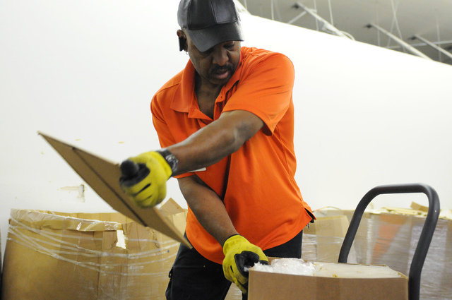 McRay Sharpe, driver at Clean the World, unloads boxes during a partnership kick-off event with the Las Vegas Sands Corp., at Clean the World's facility in Las Vegas Tuesday, April 1, 2014. Volunt ...