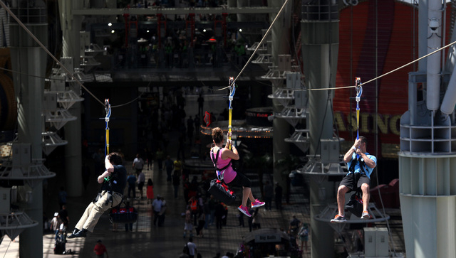 Riders fly along the zipline from Slotzilla on the second day of the attraction being open to the public above Fremont Street in Las Vegas on Monday, April 28, 2014. (Justin Yurkanin/Las Vegas Rev ...