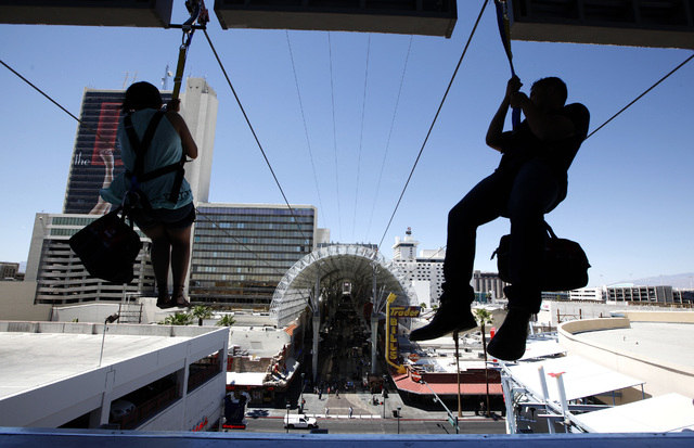 Riders shoot out of the mouth of Slotzilla on the second day of the attraction being open to the public above Fremont Street in Las Vegas on Monday, April 28, 2014. (Justin Yurkanin/Las Vegas Revi ...