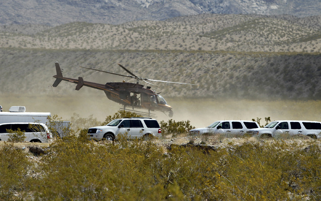 A helicopter takes off from a staging area of Bureau of Land Management vehicles and other government vehicles off of Riverside Road near Bunkerville on Saturday. The Bureau of Land Management has ...