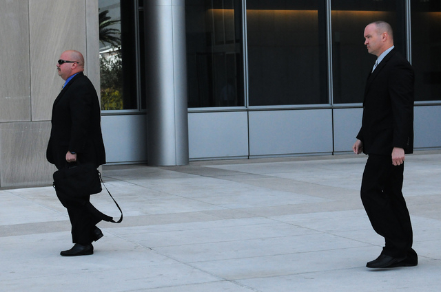 Las Vegas police officers Jason Jennings, left, and Gary Clark, leave Lloyd George Federal Courthouse in Las Vegas after their hearing Thursday, April 17, 2014. National Guard Sgt. Mark England is ...