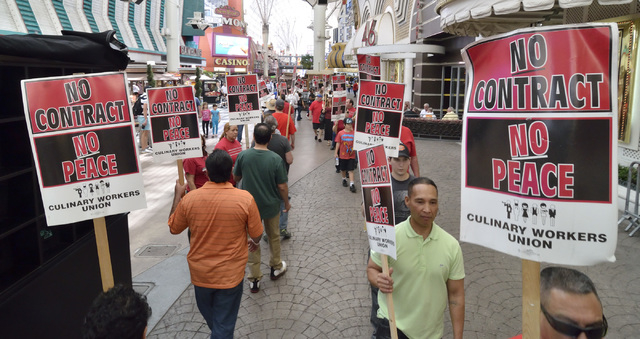 Culinary and Bartenders Union supporters picket outside of the Golden Nugget hotel-casino at 129 Fremont St. in downtown Las Vegas on Saturday, April 12, 2014. The unions, which aren't officially  ...