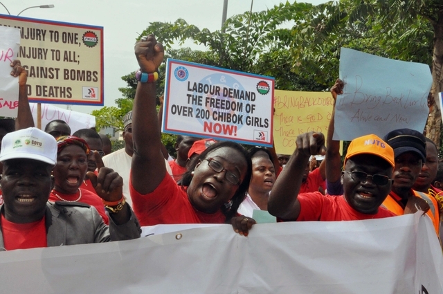 People attend a demonstration calling on the government to rescue the kidnapped school girls from the Chibok government secondary school, outside the defense headquarters in Abuja, Nigeria, Tuesd ...