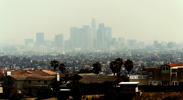 A smoky haze obscures the Los Angeles skyline Friday May 16, 2014. Smoke from several wildfires that have burned more than 1, 500 acres in Southern California have drifted north into the city.(AP  ...