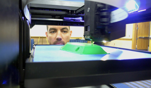 Michael Fieldson , the civilian project manager for the US Special Operations Command's Tactical Assault Light Operator Suit at MacDill Air Force Base, looks at a 3D printer during a trade show in ...