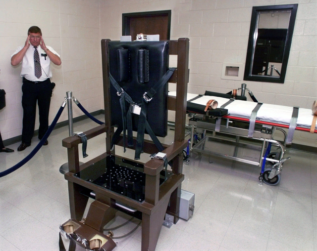 In this Oct. 13, 1999 file photo, Ricky Bell, then warden at Riverbend Maximum Security Institution in Nashville, Tenn., gives a tour of the prison's execution chamber. Republican Gov. Bill Haslam ...