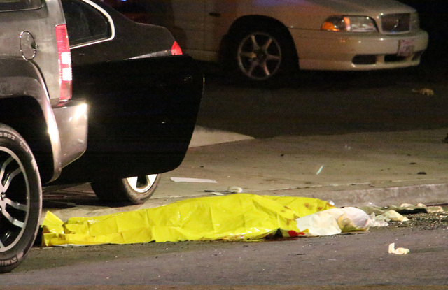 In this image provided by KEYT-TV, a body is covered on the ground after a mass shooting near the campus of the University of Santa Barbara in Isla Vista, Calif., Friday, May 23, 2014.  A drive-by ...