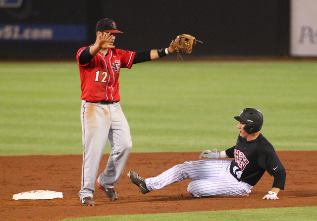 UNLV's Morgan Stotts (44) slides safely into second base as San Diego State's Tim Zier signals to his team during a game in the Mountain West baseball tournament at Earl E. Wilson Stadium in Las V ...